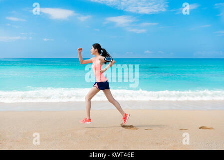 Schöne hübsche Frau, die Reisenden, die auf Strand und das Tragen von Kopfhörern Musik hören durch Mobile Smartphone im Sommer Urlaub. Stockfoto