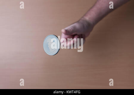 Eine konzeptuelle Bild des Werfens einer kanadischen Silber münze in der Luft. Stockfoto