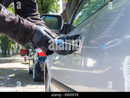 Ein Dieb versucht, die Sperre eines Auto abholen Stockfoto
