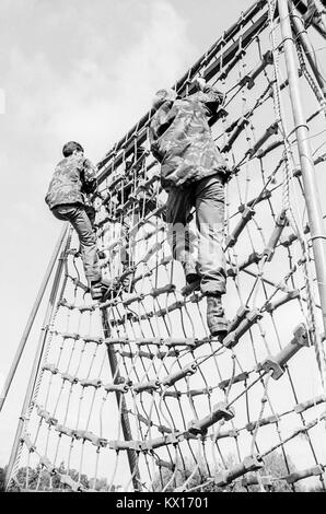 Britische Armee squaddies in der Grundausbildung klettern über Seil Verrechnung als Teil eines Hindernisparcours, 15. Juni 1993 Stockfoto