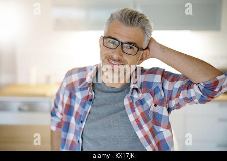 Lächelnd 40-jaehrigen Mann zu Hause stehend Stockfoto