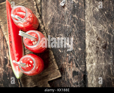 Cocktail von frisch Wassermelonen in Flaschen. Auf einer hölzernen Hintergrund. Stockfoto