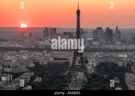 Frankreich, Paris (75), Eiffelturm mit La Defense hinter sich bei Sonnenuntergang. Stockfoto