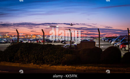 Ein Flugzeug hebt ab London Heathrow Flughafen, Abfahrt über den Flughafen, sichere Parkplätze in einem wunderschönen Sonnenuntergang Stockfoto