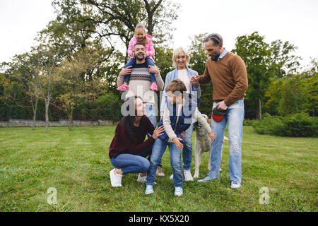 Gerne große Familie mit Labrador Retriever Hund zusammen Spaß im Park Stockfoto