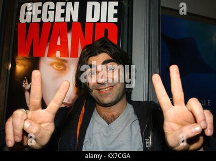 (Dpa) - der deutsche Regisseur Fatih Akin Gesten der Sieg Zeichen, als er vor einem Poster von seinem neuen Film "Gegen die Wand" (Gegen die Wand) während einer Pressekonferenz am Ende der 54. Berlinale Die Internationalen Filmfestspiele Berlin, 14. Februar 2004 steht. Akin war für seinen Film "Gegen die Wand", das war das erste Mal seit 1986, dass ein Film aus Deutschland wurde mit dem "Goldenen Bären" ausgezeichnet ausgezeichnet. Der Film erzählt die Geschichte einer jungen türkischen Frau, die frei von ihren konservativen Elternhaus zu brechen, indem sie eine Scheinehe. Der Film galt als einer der Höhepunkte der o Stockfoto