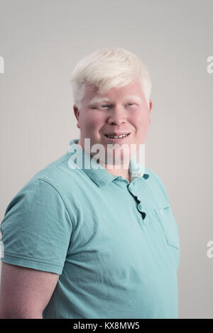 Albino junger Mann portrait. Blonde Kerl mit grauem Hintergrund isoliert. Albinismus Stockfoto