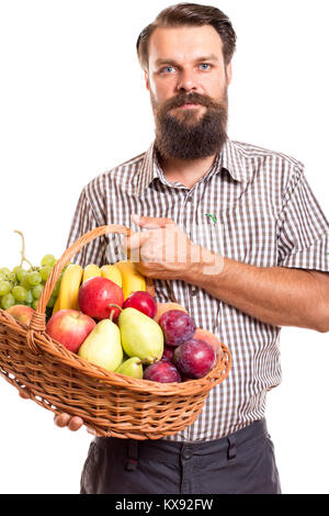Portrait von bärtigen Mann mit Korb mit Früchten vor weißem Hintergrund Stockfoto