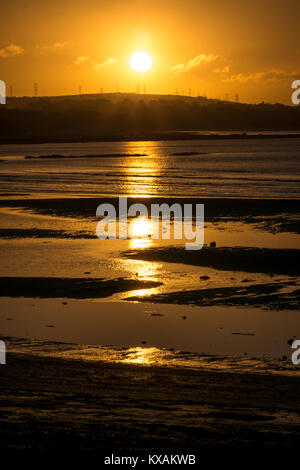 Longniddry Bents, East Lothian, Schottland, Vereinigtes Königreich. 8 Jan, 2018. Ein sehr kalter Tag zeichnet zu einem erstaunlichen Ende, mit einem orangefarbenen Sonnenuntergang über der Bucht in Richtung Edinburgh in der Ferne suchen Stockfoto