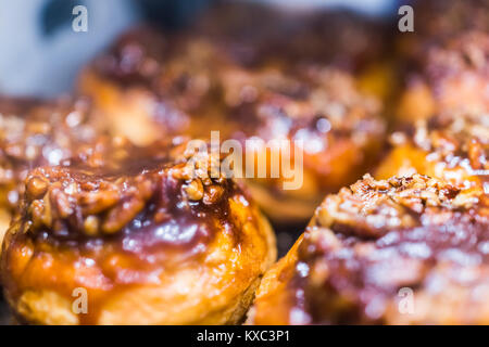 Makro Nahaufnahme Anzeige der Schokolade beträufelt Pekannuss Sticky Buns dänisches Gebäck in der Bäckerei für Frühstück karamellisierten Stockfoto