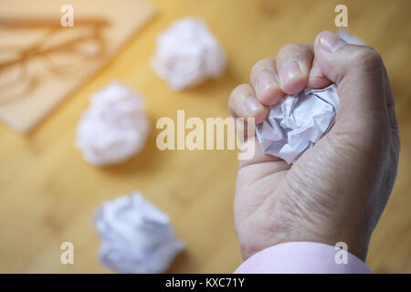 Zerknittert Papier Kugel in männlicher Hand auf Office Tabelle Stockfoto