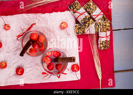 Diät Müsliriegel mit detox Apfel-zimt Wasser auf rote Paprika und Holz- Hintergrund. Ansicht von oben. Flach Stockfoto