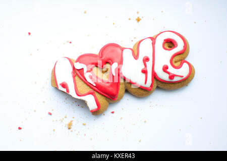 Eine gebissen Cookie für Valentinstag oder für eine Hochzeit Tag und Krümel auf einem weißen Hintergrund. Ansicht von oben, flach, kopieren. Stockfoto