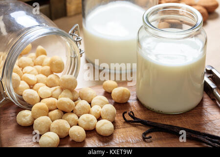 Milch von Macadamia-nüssen auf einer hölzernen Oberfläche Stockfoto