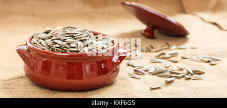 Ungeschälten Sonnenblumenkerne in einem keramischen Topf Stockfoto