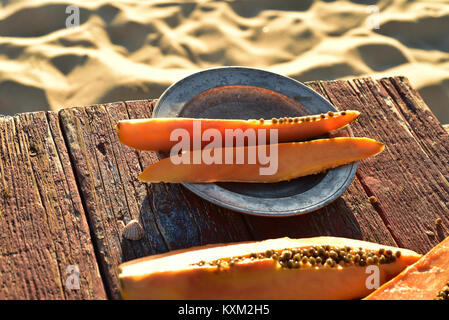 Frisch papaya auf rustikalen Holztisch sand Strand Küste Baja, Mexiko Stockfoto