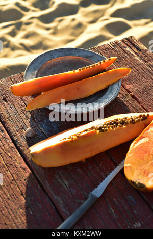 Frisch papaya auf rustikalen Holztisch sand Strand Küste Baja, Mexiko Stockfoto