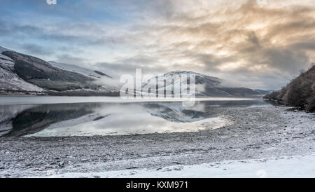 De Winter Landschaften: Blick über Loch Broom auf die verschneiten Berge vom verschneiten Ufer am Buchstaben, Ullapool, Scottish Highlands, Schottland Stockfoto