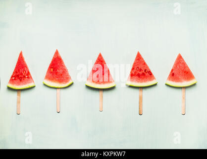 Wassermelone Schicht Eis am Stiel auf hellem Türkis Hintergrund, Ansicht von oben. Gesunde Ernährung und vegetarische Konzept Essen Stockfoto