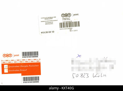 Ein Foto eines Einschreibebriefes, eines Einschreibebriefes, der in Deutschland für die verifizierte Postzustellung verwendet wird, mit Postkennzeichnungen und Unterlagen, die die Empfangsbestätigung gewährleisten. Stockfoto