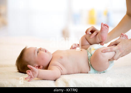 Mutter oder masseuer Massieren baby boy in Kinderzimmer Stockfoto