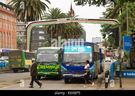 Blick hinunter Kenyatta Avenue mit der Nairobi City County Schild über der Straße für Busse warten an der Ampel und Fußgänger die Straße überqueren, Nairobi Stockfoto