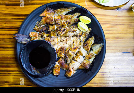 Den gegrillten Lachs Fisch Kopf auf einem Teller, chinesischen Imbiss Stockfoto