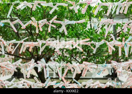 Nahaufnahme von omikuji Wahrsagen Papiere auf String gebunden. Stockfoto