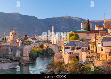 Skyline der Stadt Mostar mit der Brücke von Mostar, Häuser und Minaretten, den Sonnenuntergang in Bosnien und Herzegowina. Stockfoto