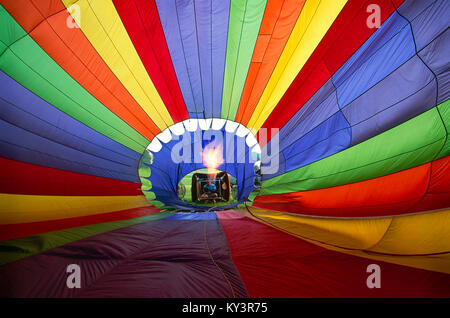 Blick von der Innenseite der Heißluftballon als Feuer erwärmt die Luft, der Ballon steigt aus dem Boden. Stockfoto