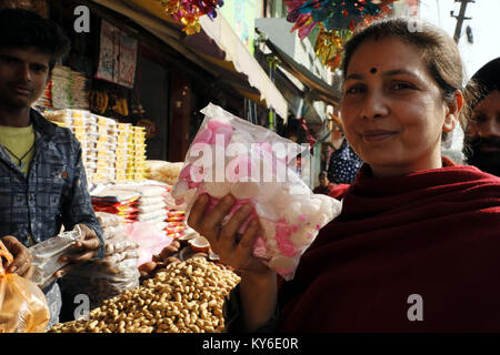 Jammu, Indien. 12 Jan, 2018. Indische Menschen kaufen üblichen eatables wie Erdnüsse, Popcorn und andere Snacks für den Lohri Festival von einem Straßenrand shop inJammu. Auf der lohri Tag Leute fliegen Drachen in den Tag und in der Nacht ein Lagerfeuer, um das Ereignis zu feiern. Lohri, eines der wichtigsten Festivals des Punjab, markiert den Höhepunkt des Winters und wird im Monat Januar jedes Jahr gefeiert. Credit: Shilpa Thakur/Pacific Press/Alamy leben Nachrichten Stockfoto