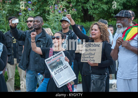 Die Menschen zuerst anheben, wie sie schreien "Schwarze Leben' an BlackoutLDN 2015 im Grosvenor Square in der Nähe der US-Botschaft in Solidarität mit den schwarzen Opfer der polizeilichen Tötungen in den USA. Stockfoto