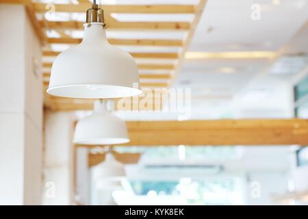 In der Nähe von wunderschönen weißen einfach moderne Deckenleuchten im Restaurant mit verschwommenen Hintergrund Kopie Raum. Stockfoto