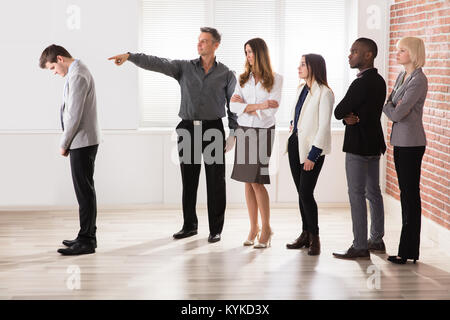 Reifen Geschäftsmann in Richtung sein Kollege im Büro Stockfoto