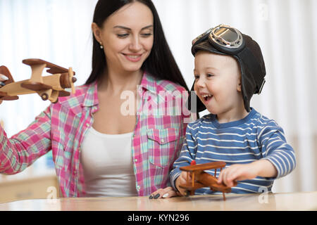 Mutter und Kind Sohn spielen mit Holz- Ebenen. Stockfoto