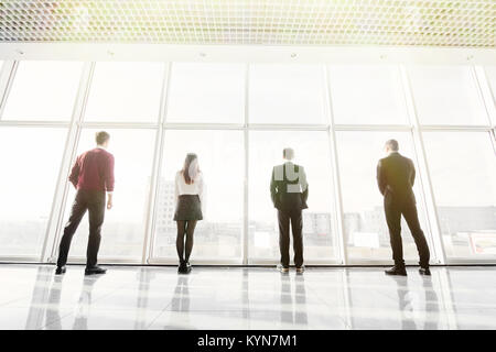 Rückansicht Silhouetten von fouw Geschäftspartner nachdenklich durch ein Büro. Mannschaft der Geschäftsleute, die in der Furcht oder Risiko beobachten Stadtbild Stockfoto