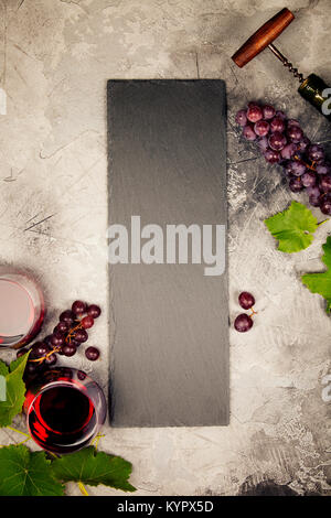 Blick von oben auf eine leere Kreidetafel für eine Liste oder ein Menü mit Wein und Imbiss. Auswahl an Käse, Oliven, Schinken, Fleisch, Baguette, Scheiben, schwarz Gr Stockfoto