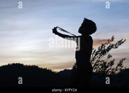 Junge Landarbeiter mit sling shot - in Me Cang Chai Berge, Yen Bai Provinz, im nordwestlichen Teil von Vietnam. Stockfoto