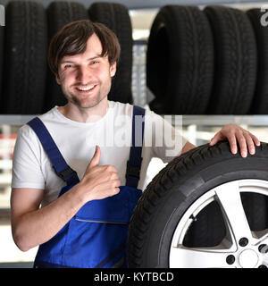 Arbeitnehmer in ein Lager mit Reifen für das Auto Stockfoto