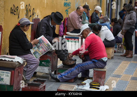 Otavalo, Ecuador - 30. Dezember 2017: Schuhputzmaschine/-service Dienstleistungen entlang der Straße der indigenen Stadt Stockfoto