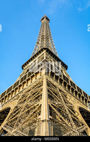 Symmetrische niedrigen Winkel Blick auf den Eiffelturm gegen den blauen Himmel. Stockfoto