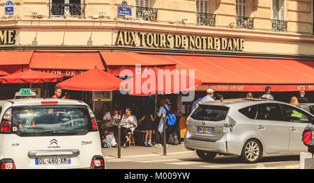 PARIS, Frankreich, 11. Juli 2017: Autos fahren an der Terrasse des Restaurant neben der Kathedrale Notre Dame im Sommer Stockfoto