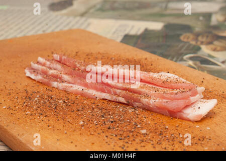 Gebackene Scheiben Speck auf einem dunklen Hintergrund. Stockfoto