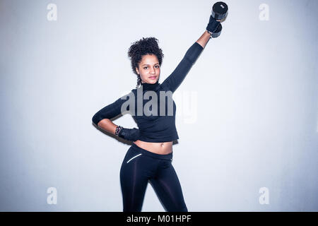 Porträt der jungen Frau auf der Suche an der Kamera anbringen, während das Halten eines Stockfoto