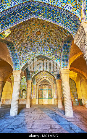 SHIRAZ, IRAN - Oktober 12, 2017: Die shabestan (gebetsraum) Der vakil Moschee mit schönen Fliesen- Gewölbe, Steinsäulen und muqarnas Details in mihrab, Stockfoto