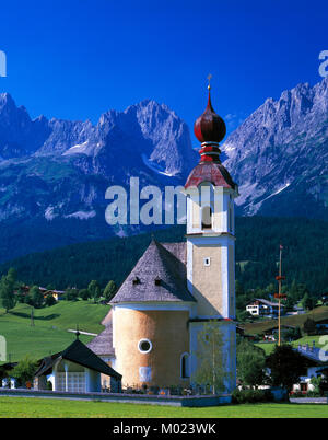 Gehen Kirche und Dorf und die Kaiser Wilhelm mountain range, Tirol, Österreich Stockfoto