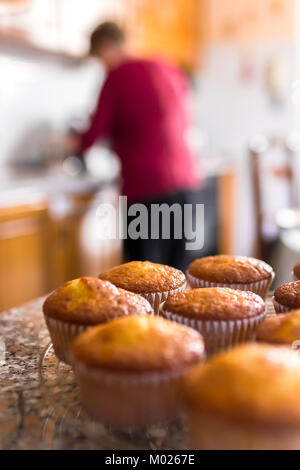 Batch an hausgemachten frisch gebackenen Kuchen oder Muffins Kühlung auf einem Regal in der Küche in der Nähe zu sehen, mit selektiven Fokus. Defokussierten blurry Ba Stockfoto