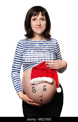 Neues Leben und neue Jahre Konzept. Schwangere Frau und Ihren Bauch mit Weihnachtsmütze isoliert auf weißem Stockfoto