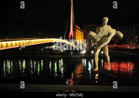 Statue" das Gewicht von Sich Selbst 'r Fluss Saône in Lyon, die individuellen und gesellschaftlichen Verantwortung vor der spektakulären beleuchteten Hintergrund Stockfoto
