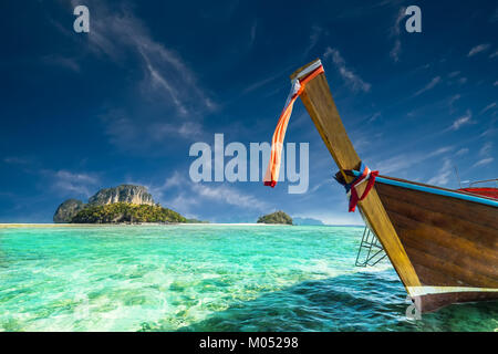 Traditionelle thailändische Holzboot mit Ribbon Dekoration an der Küste in der Nähe von Koh Tup Island. Thailand, Provinz Krabi, Ao Nang Stockfoto